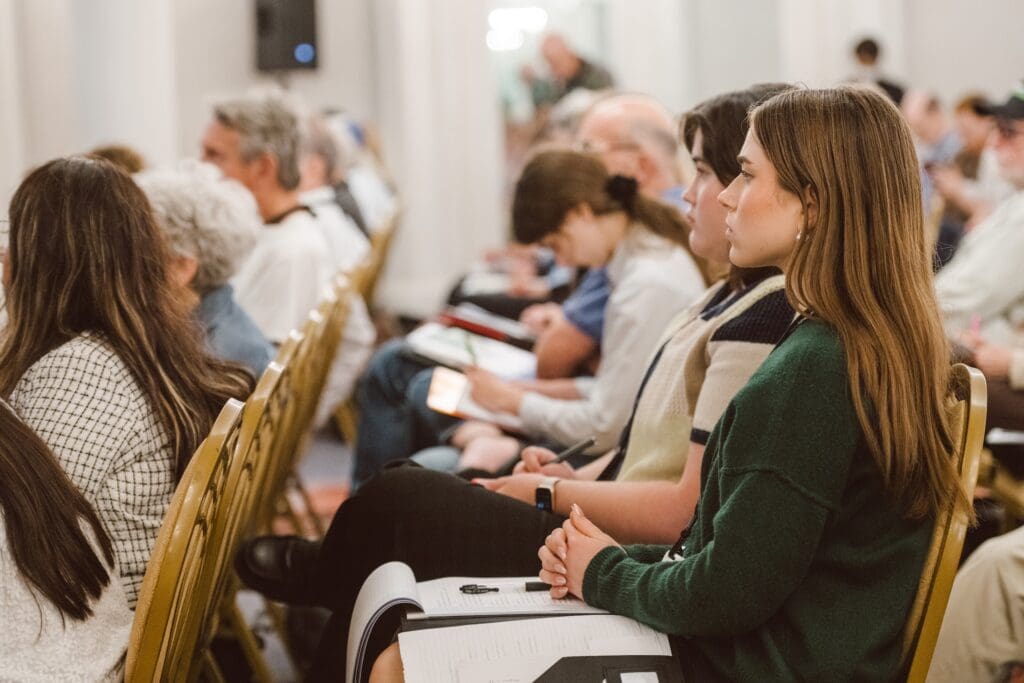 A volunteer listening at a conference