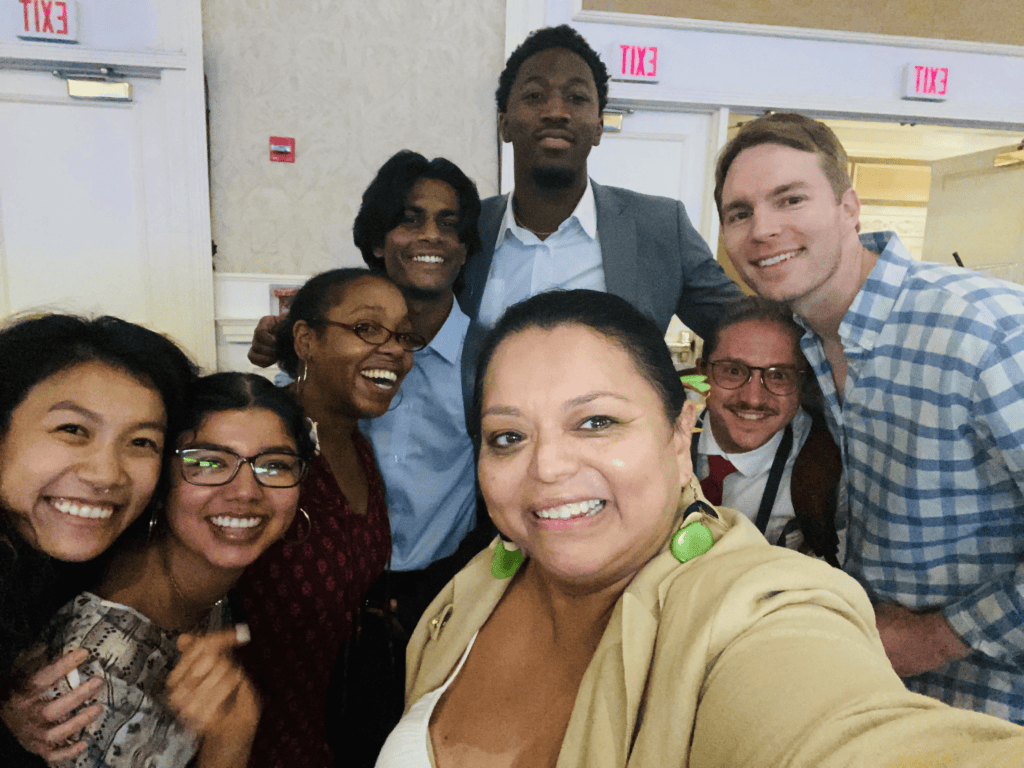 Karina Ramirez and 7 volunteers of various ethnicities in a selfie at the CCL national conference